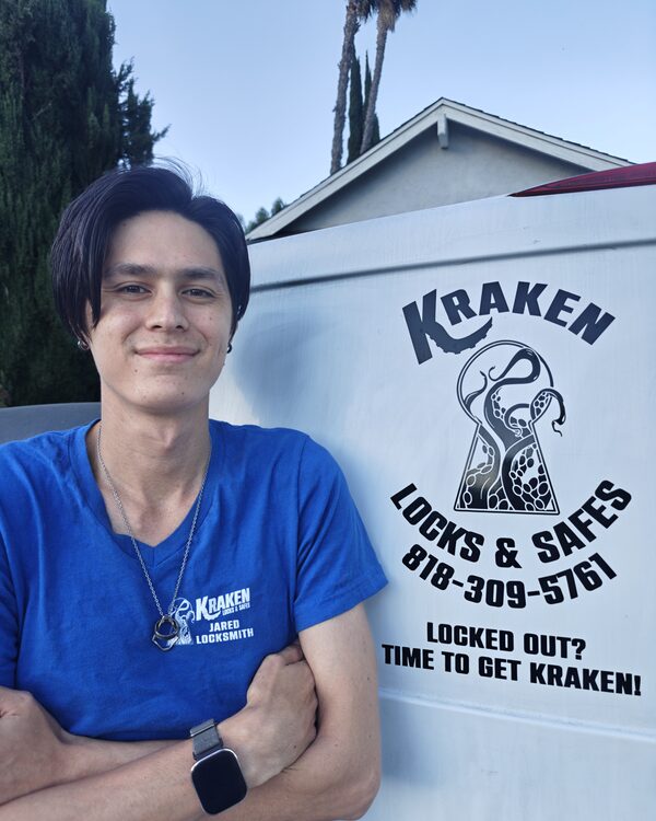 Jared Dygert, co-owner and licensed locksmith at Kraken Locks & Safes, standing beside the branded Kraken service van
